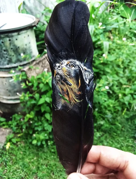 Two loyal companions painted on a dark feather